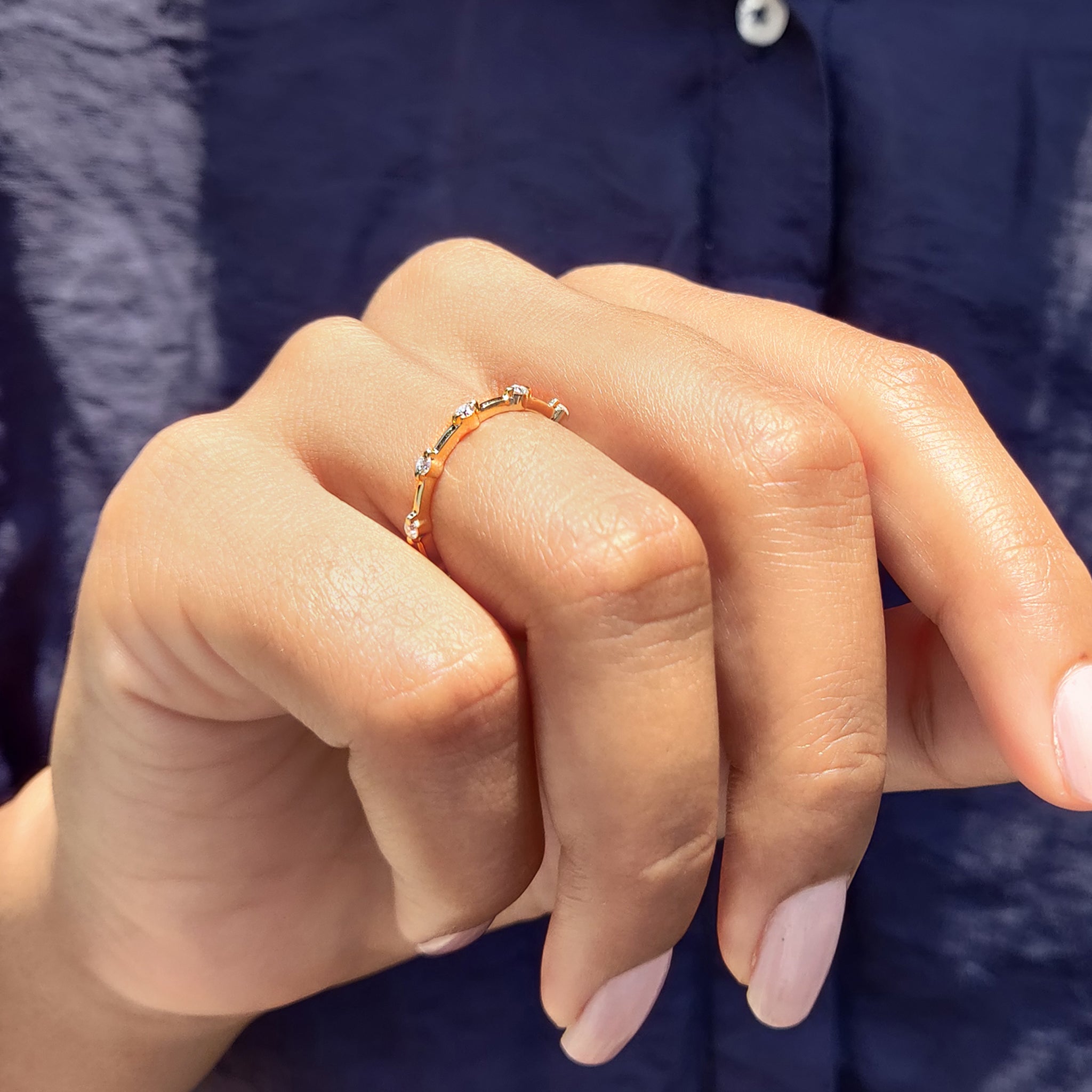 Yellow gold wedding band featuring pave stones.