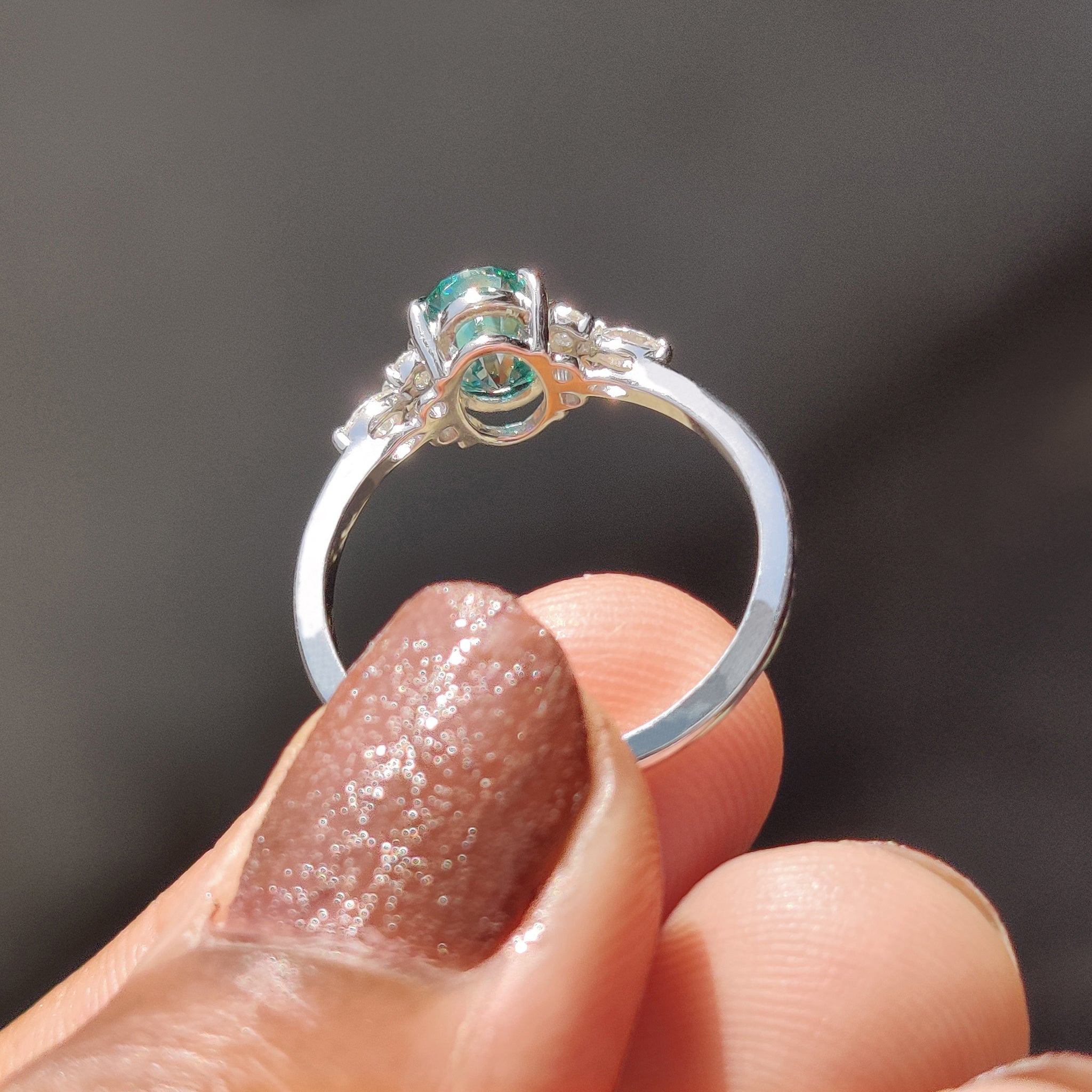 Cyan Blue oval cut ring set in white gold.
