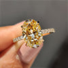 Oval Moissanite engagement ring set in yellow gold with a stunning pave setting band.