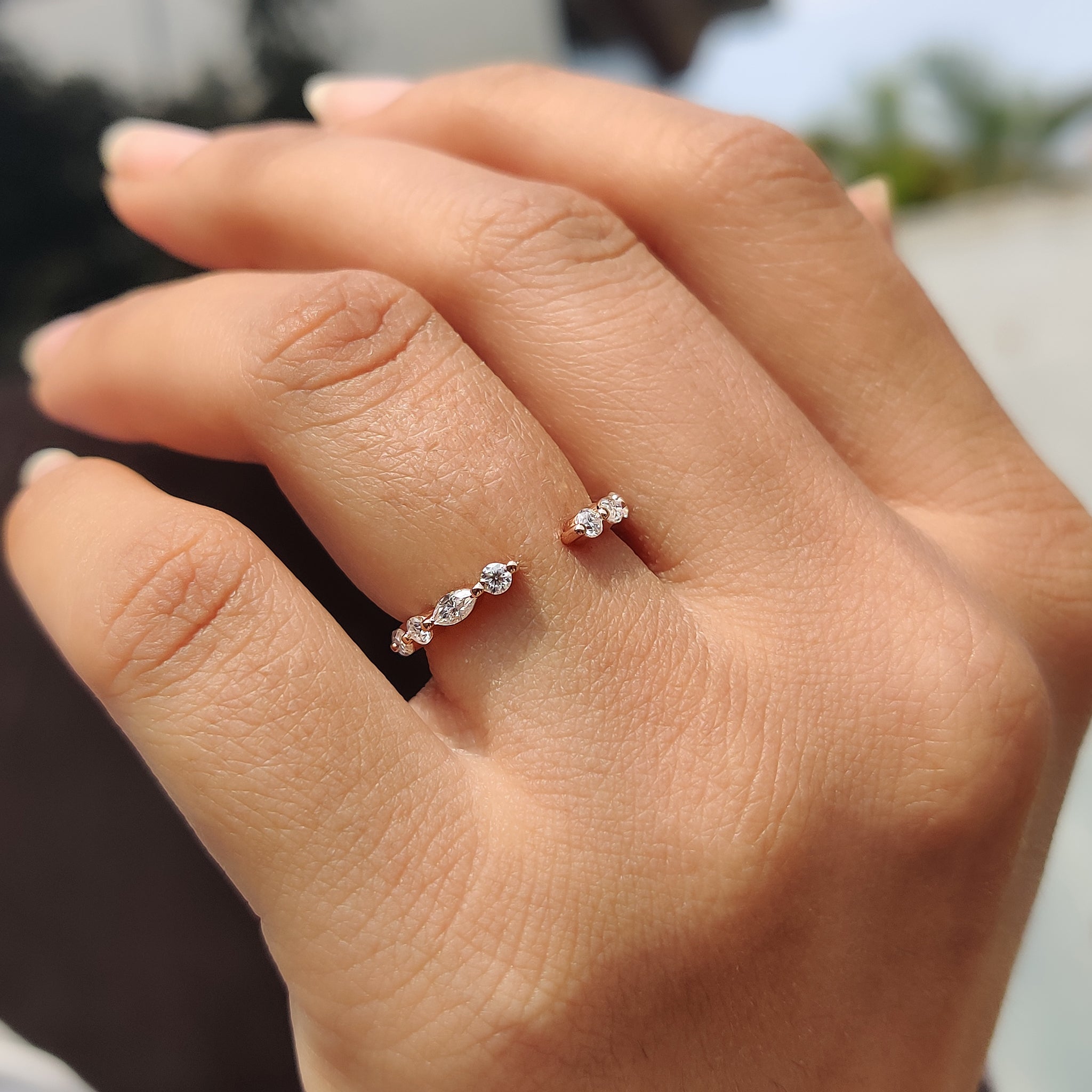 Open gap wedding band with a round cut band and floating bubble prong.
