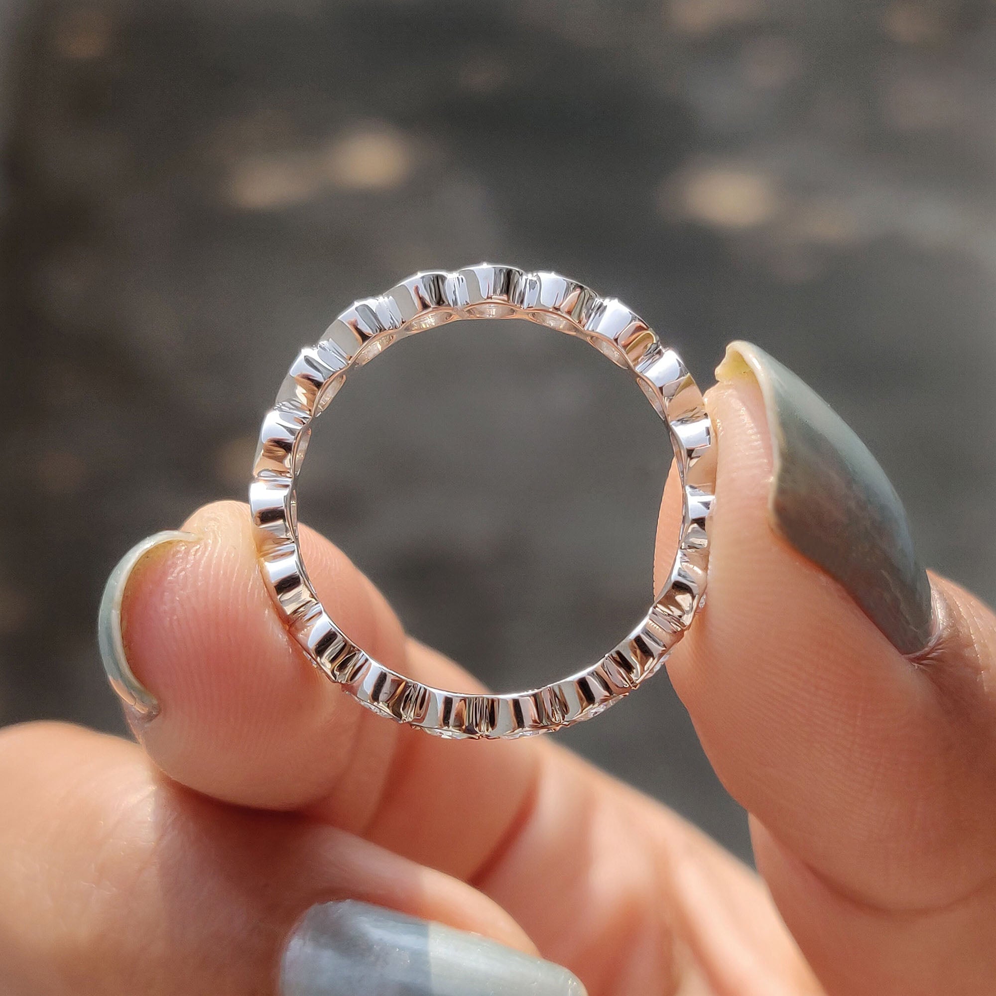 Custom moissanite band with personalized design.
