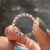 Custom moissanite band with personalized design.
