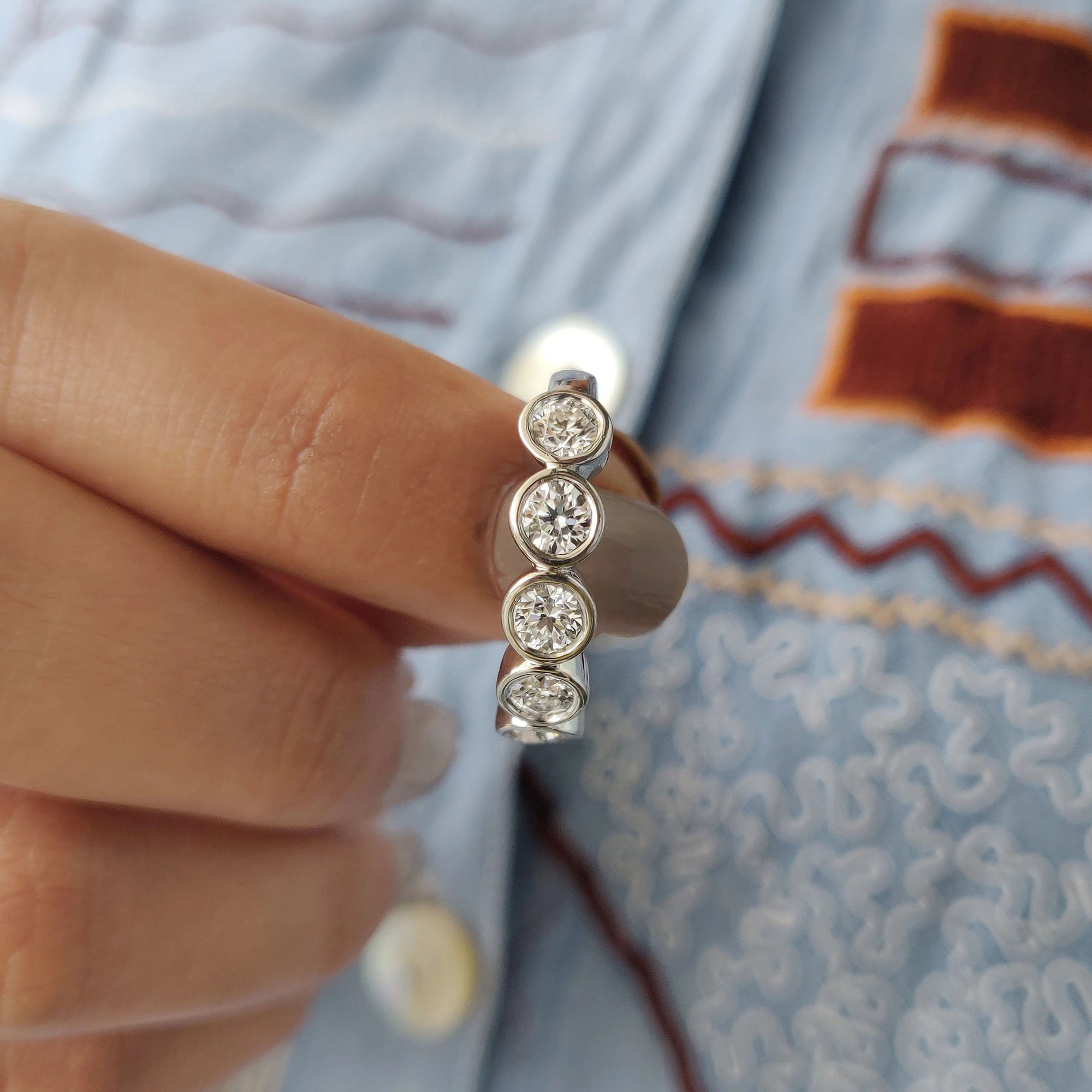 White gold band with moissanite stones.
