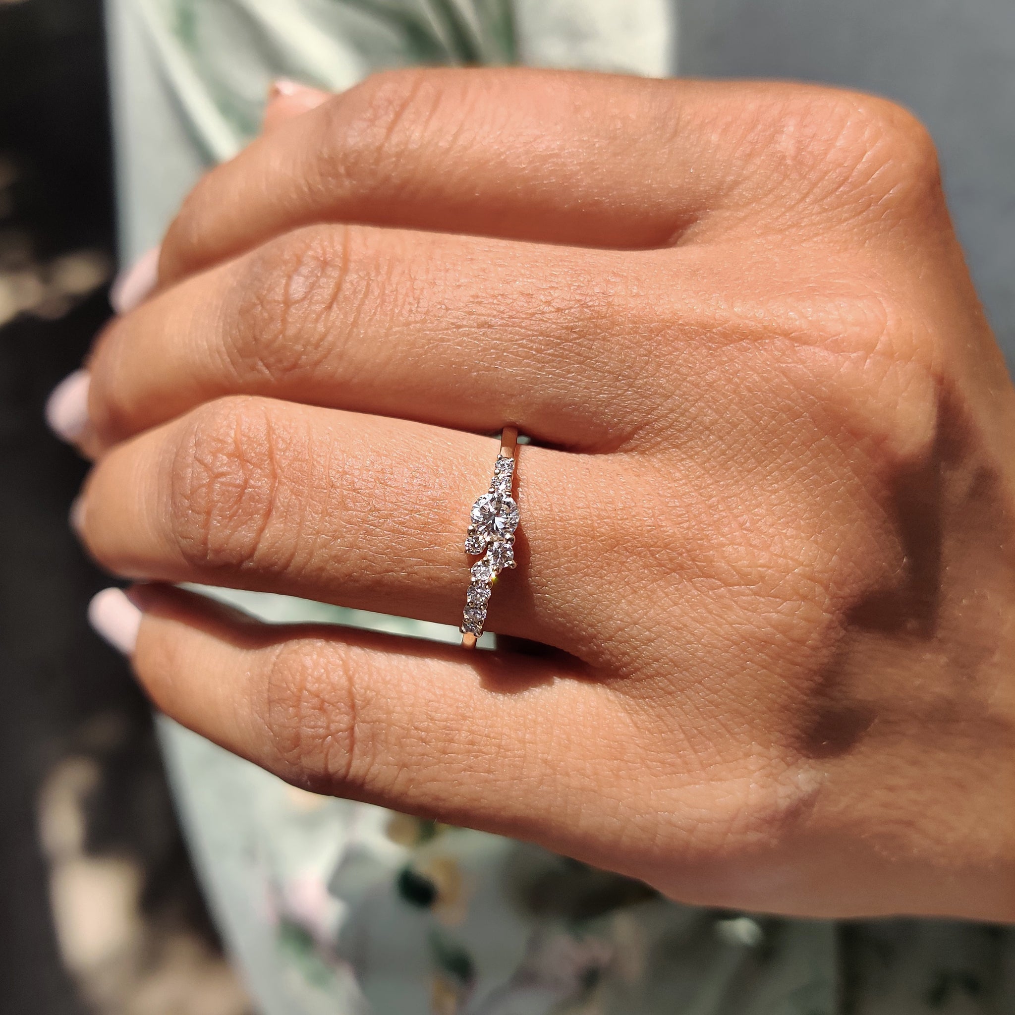 Cluster engagement ring with diamonds set in a radiant design.
