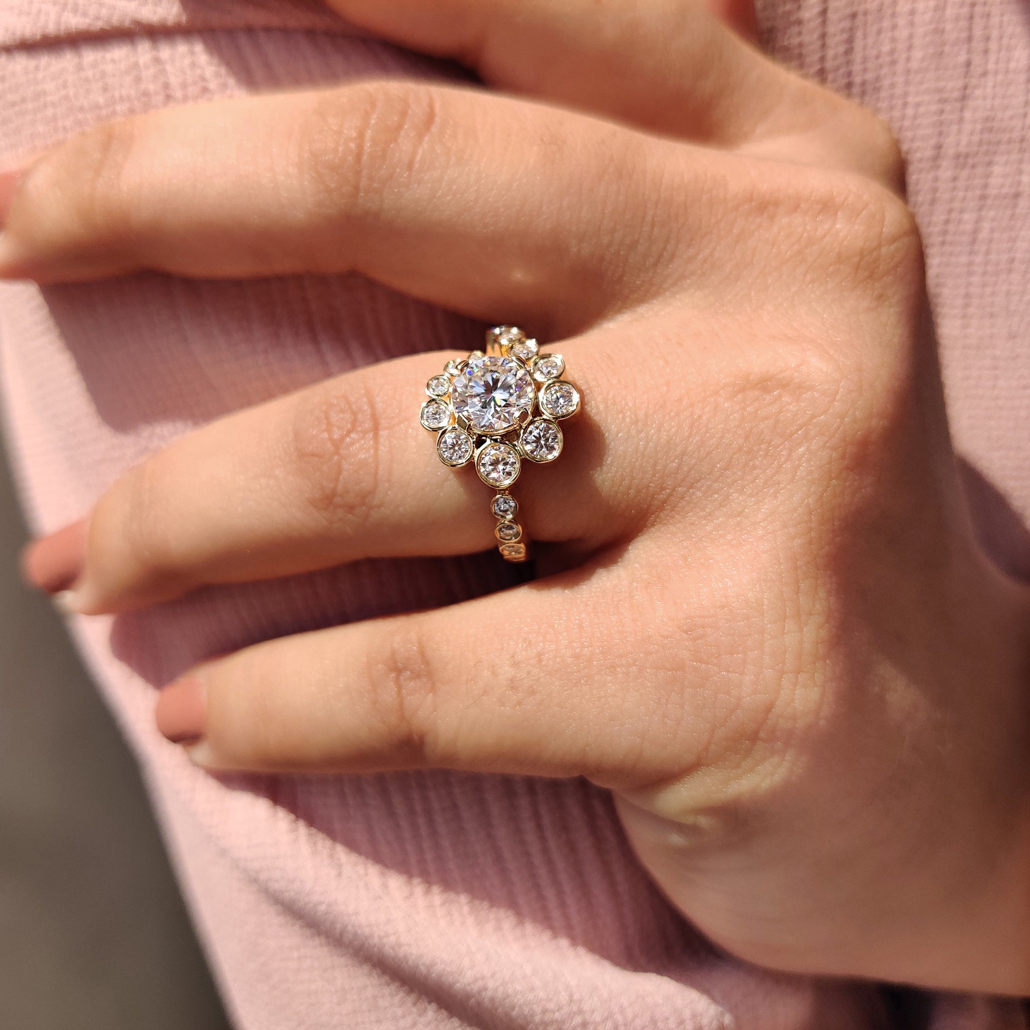 Handmade ring with a round halo design and pave band for a touch of elegance.
