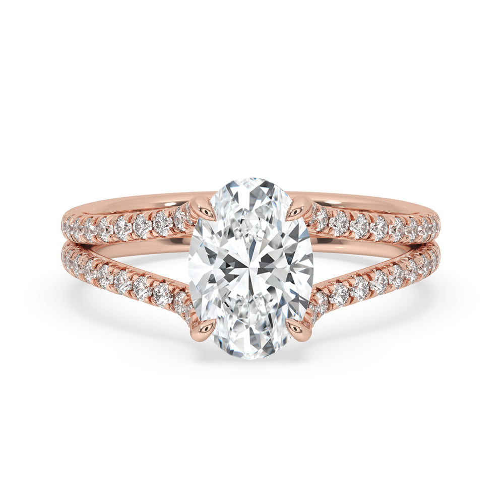 Hidden halo oval engagement ring with oval cut diamond and pave band, featuring claw prongs and handmade jewelry craftsmanship.