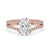 Hidden halo oval engagement ring with oval cut diamond and pave band, featuring claw prongs and handmade jewelry craftsmanship.