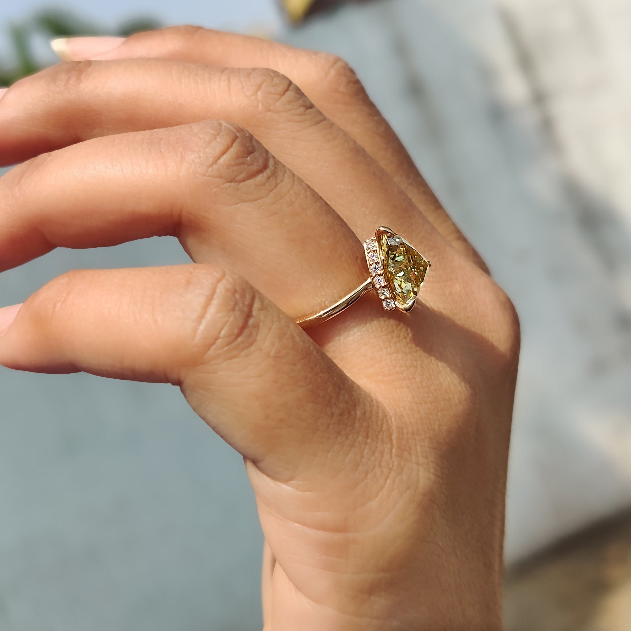 Rose gold engagement ring with a brilliant trillion cut diamond and solitaire setting.