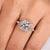 Princess cut diamond ring with four claw prong setting.
