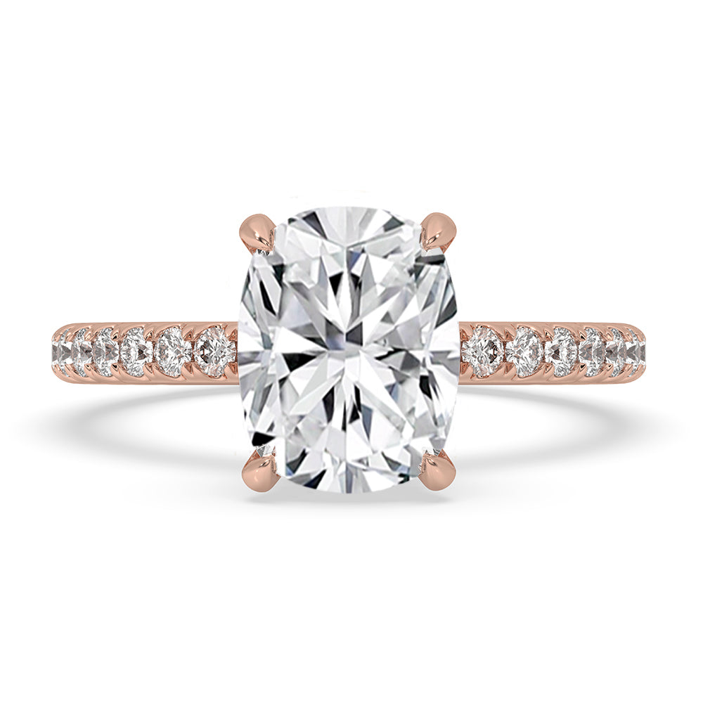 Cushion diamond ring with pave setting in rose gold.
