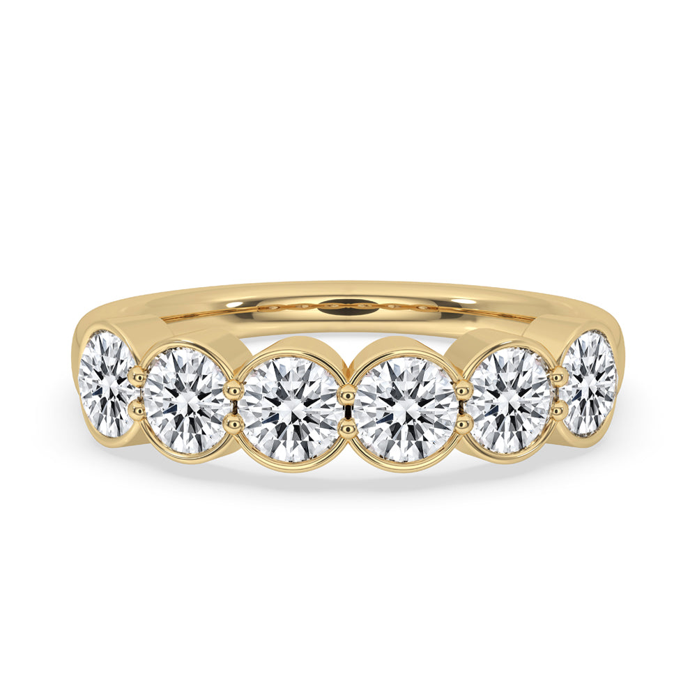 Bezel set diamond band with round cut diamonds in yellow gold band.
