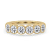 Bezel set diamond band with round cut diamonds in yellow gold band.
