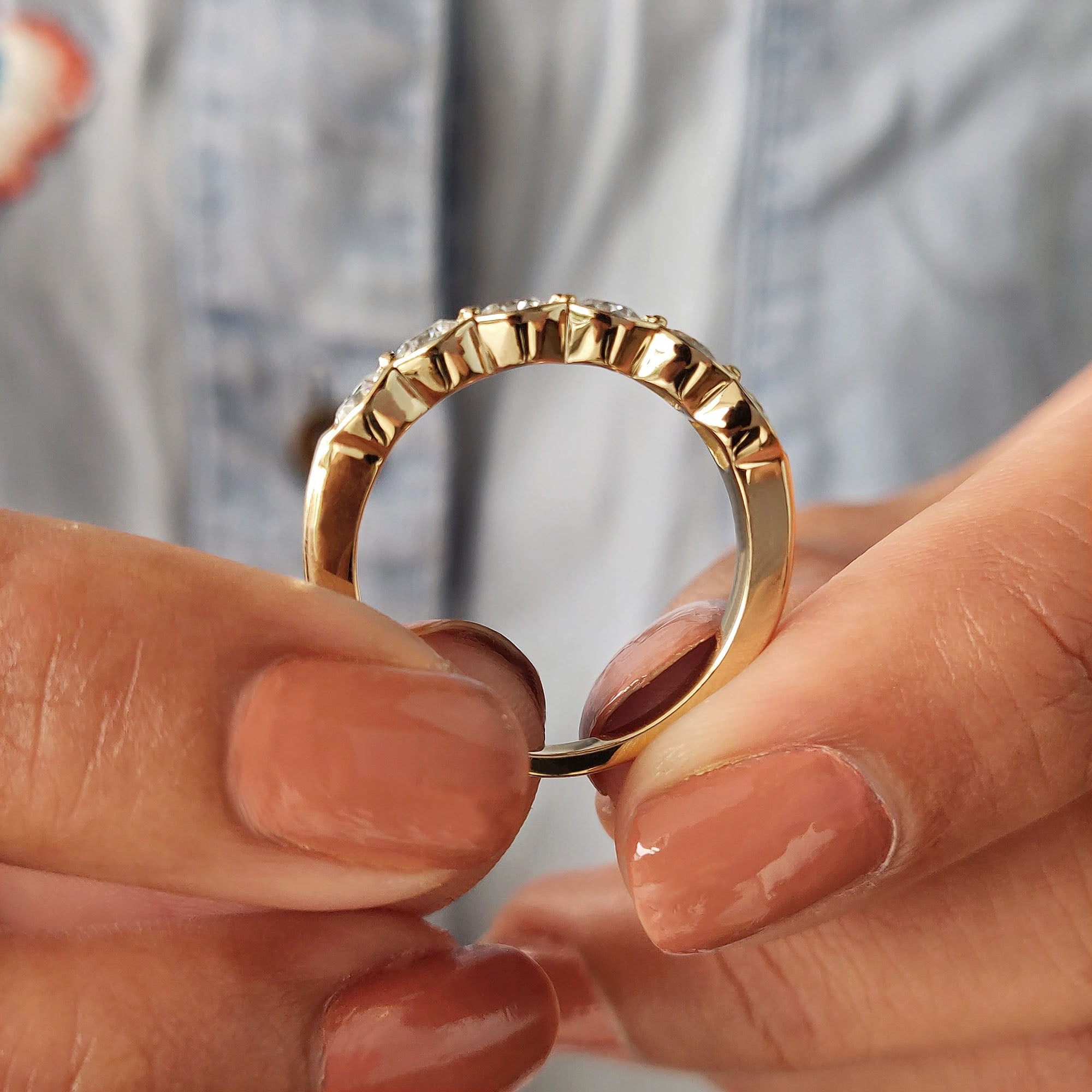 Bezel set wedding band in yellow gold with custom details and carat diamonds.
