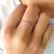 Half eternity band with sparkling round cut stones in a handcrafted design.
