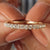 Rose gold moissanite wedding band with moissanite half eternity band.
