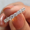 Moissanite eternity band white gold pairs perfectly with round cut wedding band.
