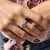 A cyan blue engagement ring adds a bold twist.