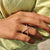 Round cut moissanite band crafted for subtle sparkle and a timeless yellow gold finish.