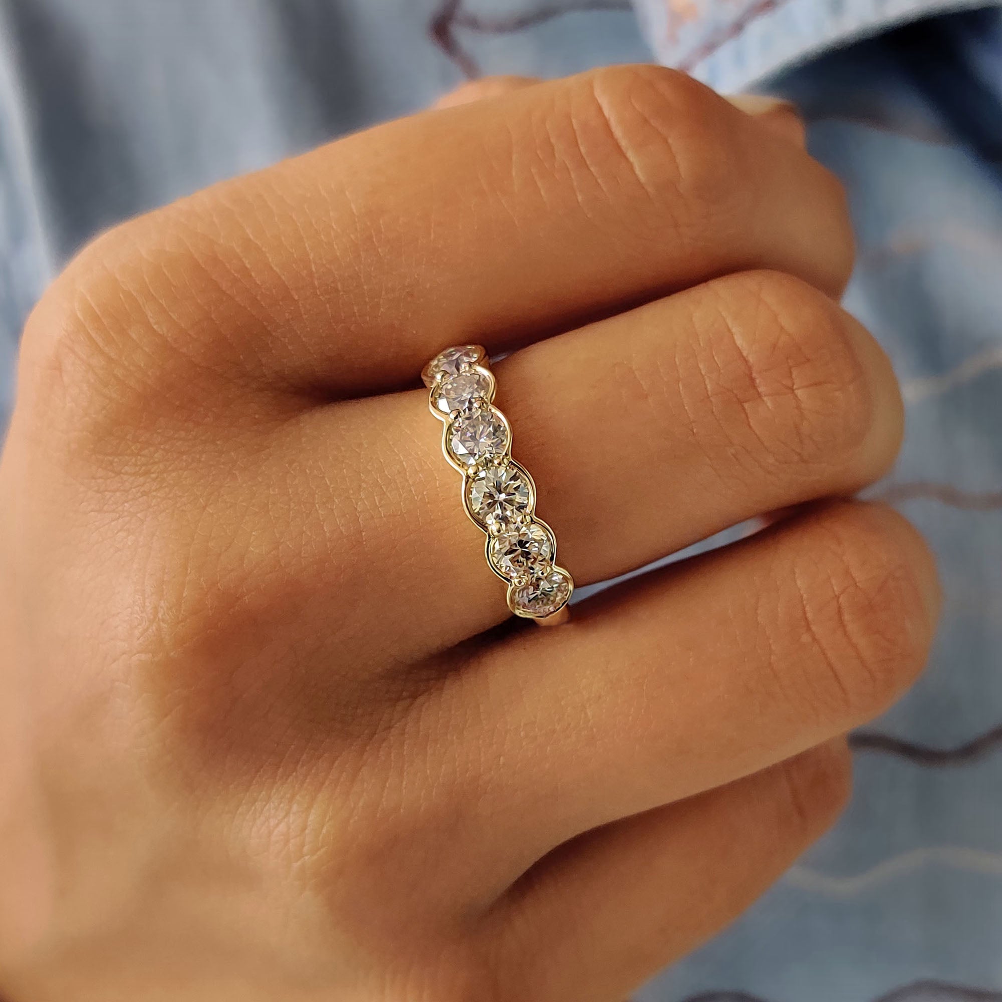 Yellow gold band featuring handmade details and moissanite sparkle.
