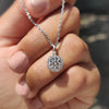 Diamond halo pendant with round diamond in white gold.
