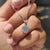 Diamond halo pendant with round diamond in white gold.
