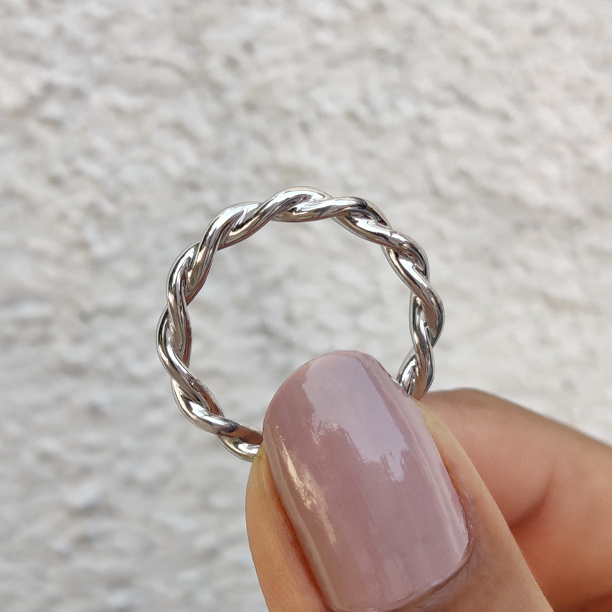 A twisted wedding band enhances the charm of a custom wedding band.
