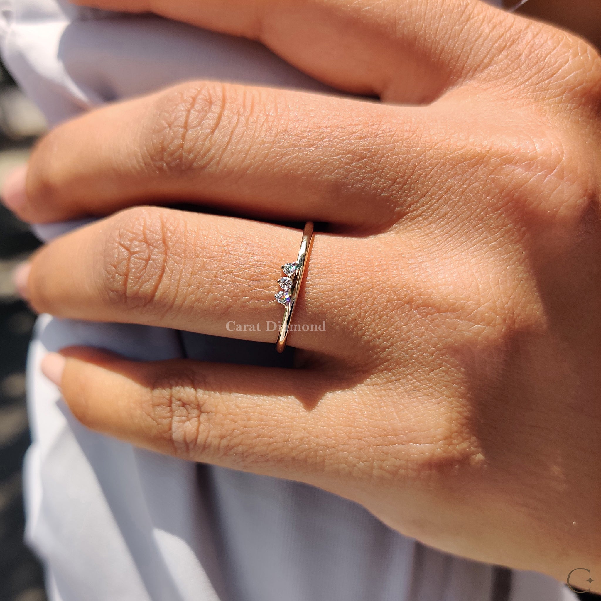 Prong setting diamond wedding band with three stones.
