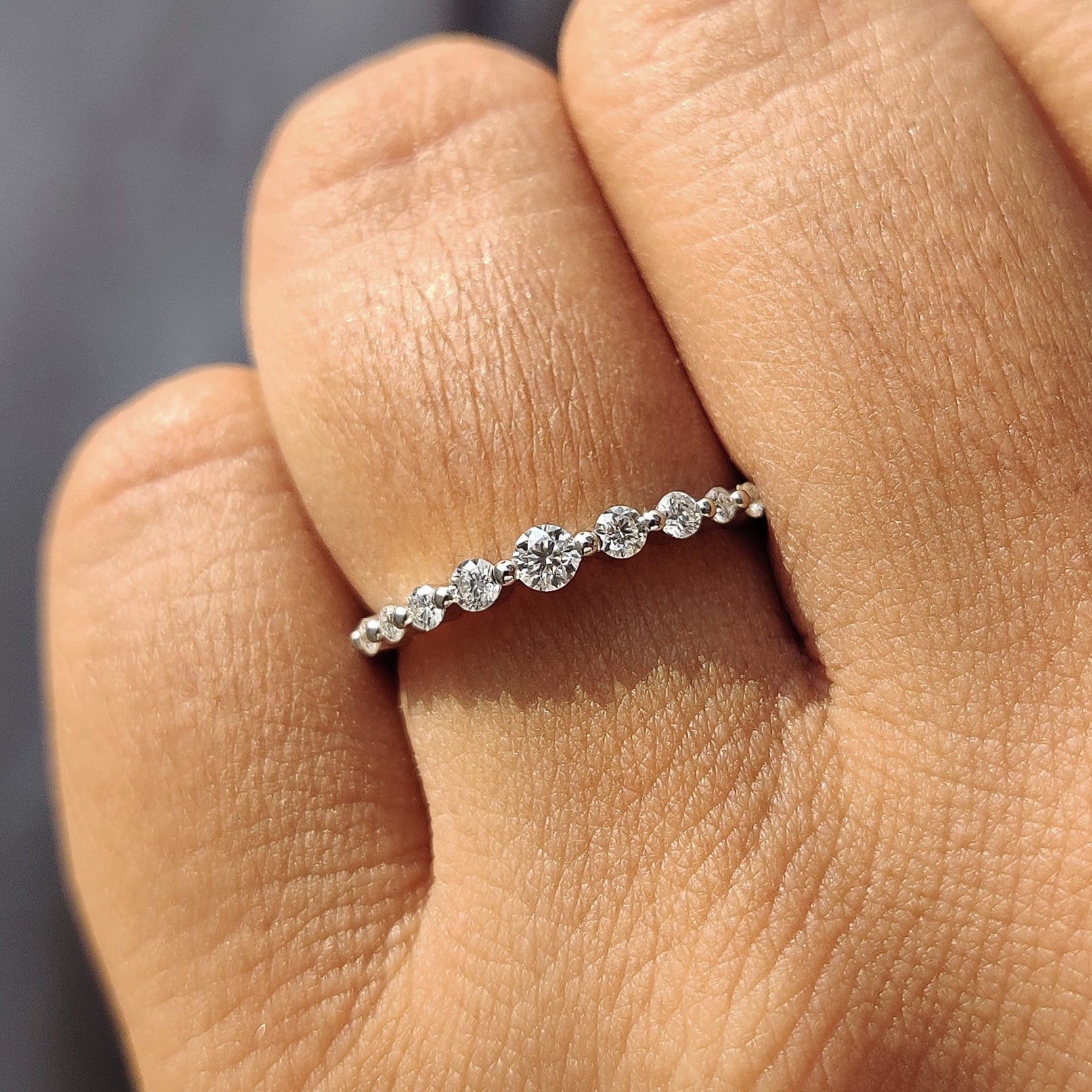 7 stone wedding band with sparkling round diamonds.
