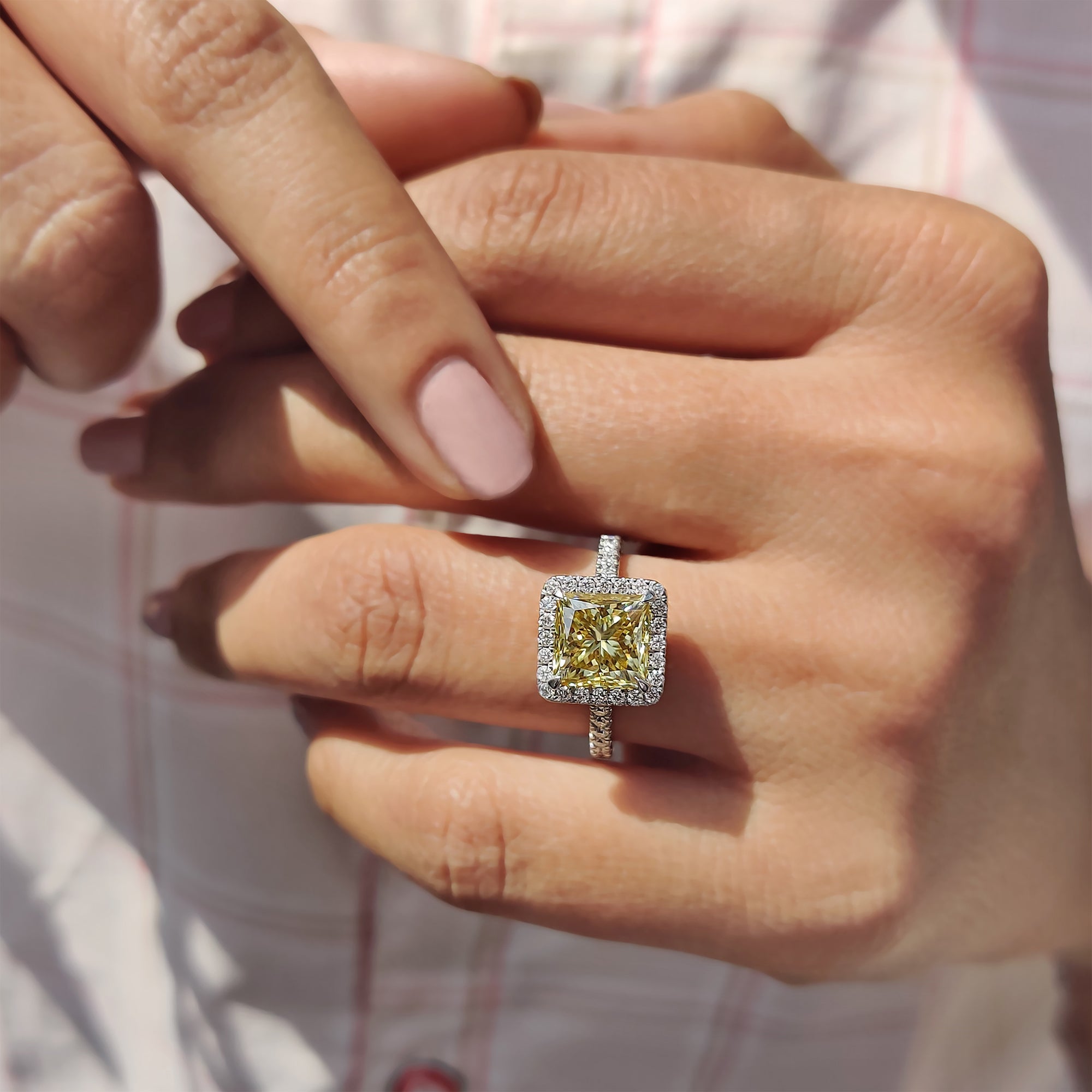 Round cut side stones complete the ring with bright charm.