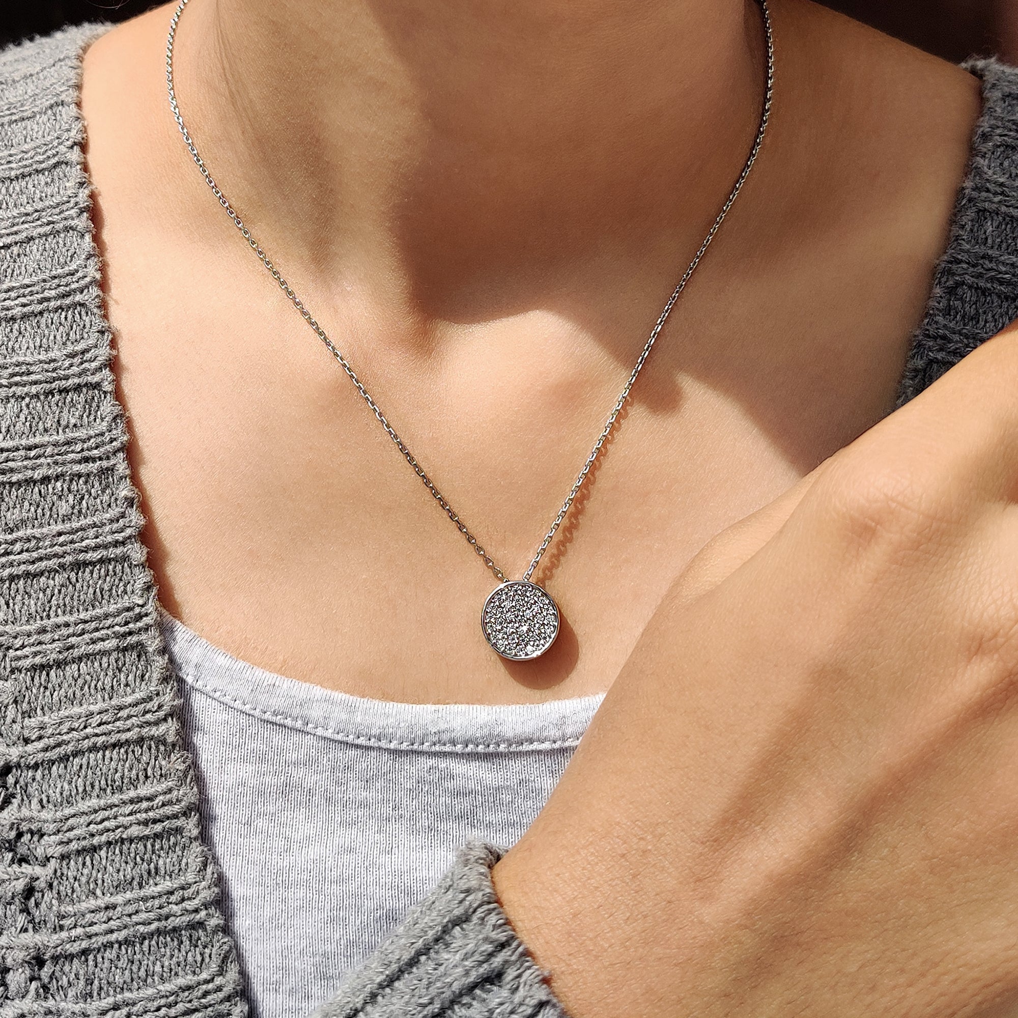 White gold pendant with a cluster of round diamonds.
