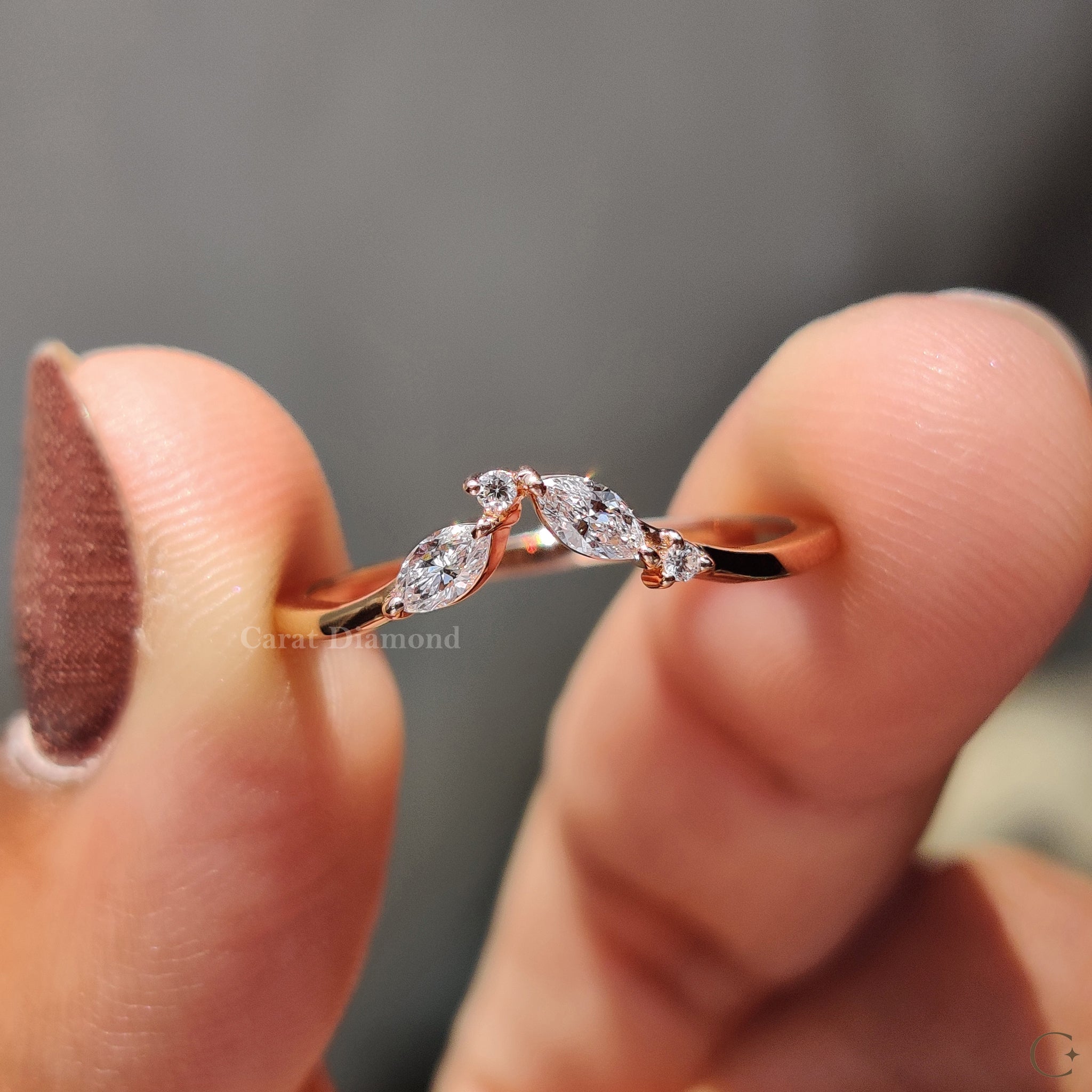 Prong set diamond band resting on a velvet jewelry box.
