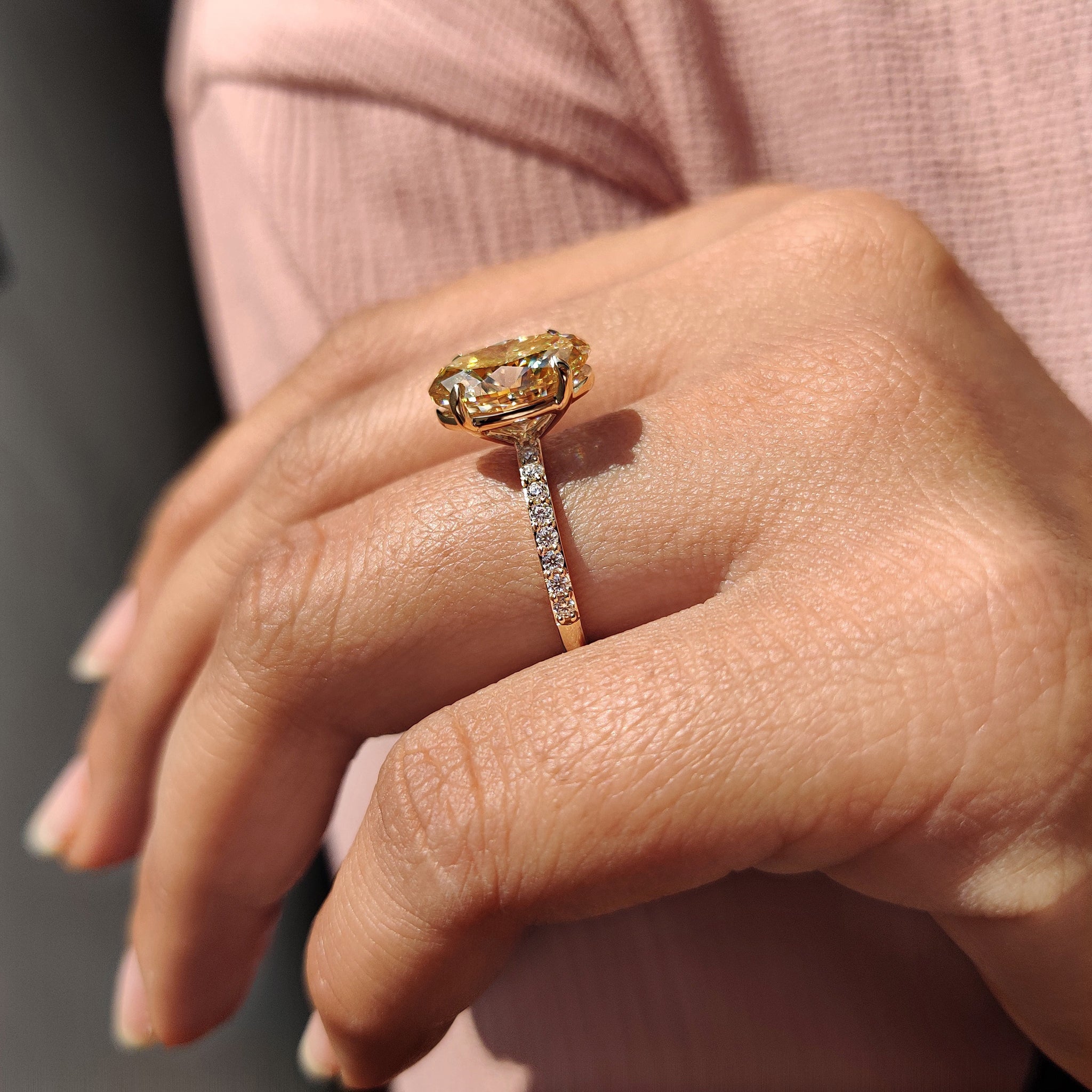 Pave setting band with oval Moissanite center stone makes this engagement ring stand out.