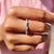 Oval cut eternity band with moissanite stones, crafted in white gold.
