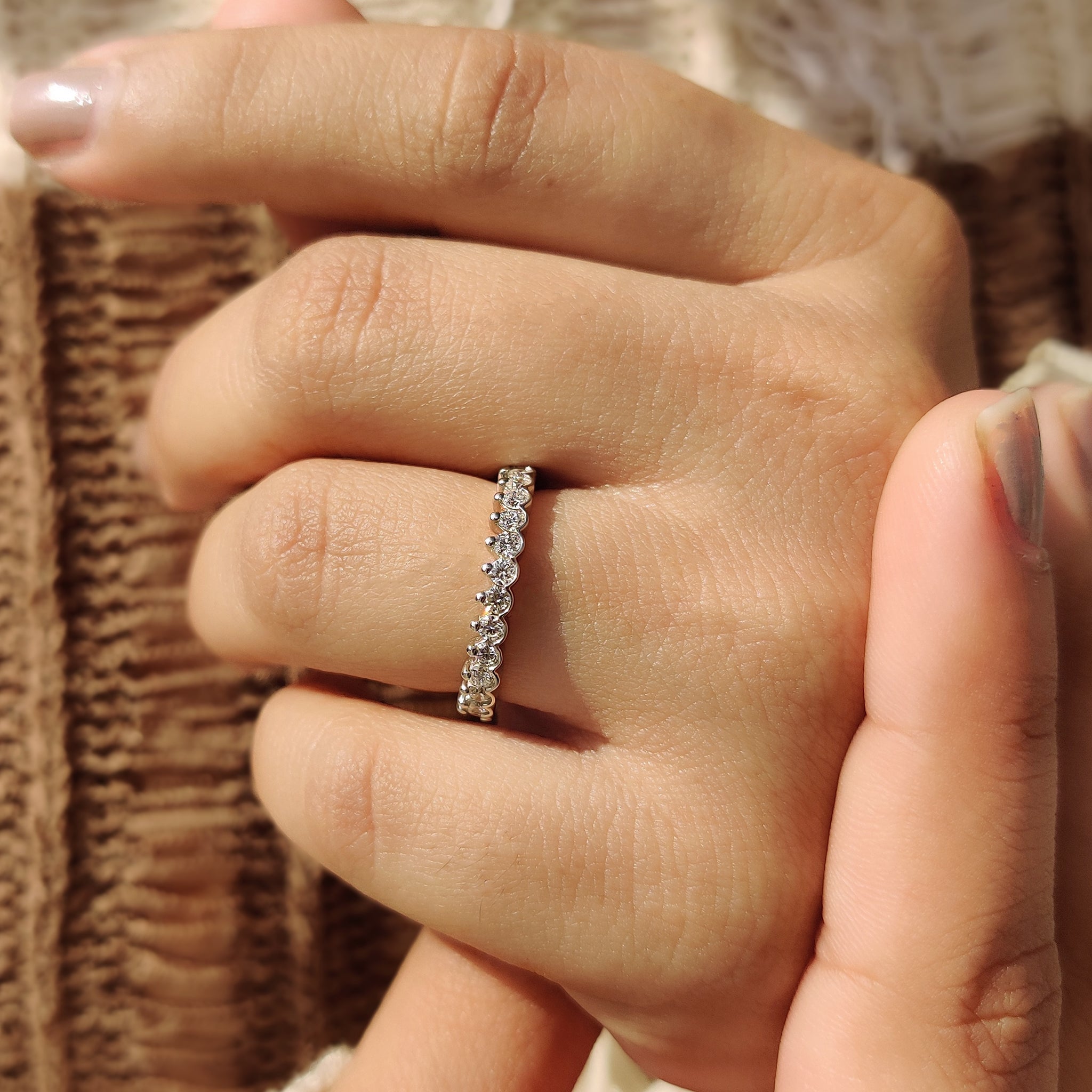 Handmade jewelry featuring a round wedding band with diamonds.
