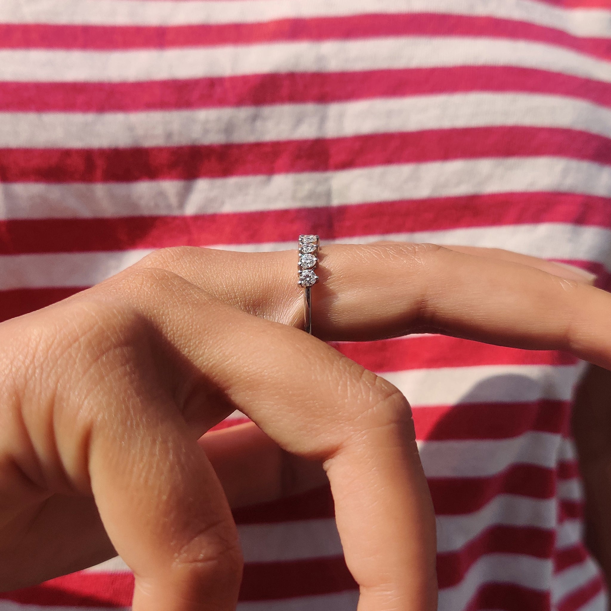 Round cut moissanite band offering classic brilliance in a simple half eternity design.