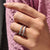 Twisted band featuring round accents, perfect for stacking or pairing with engagement rings.