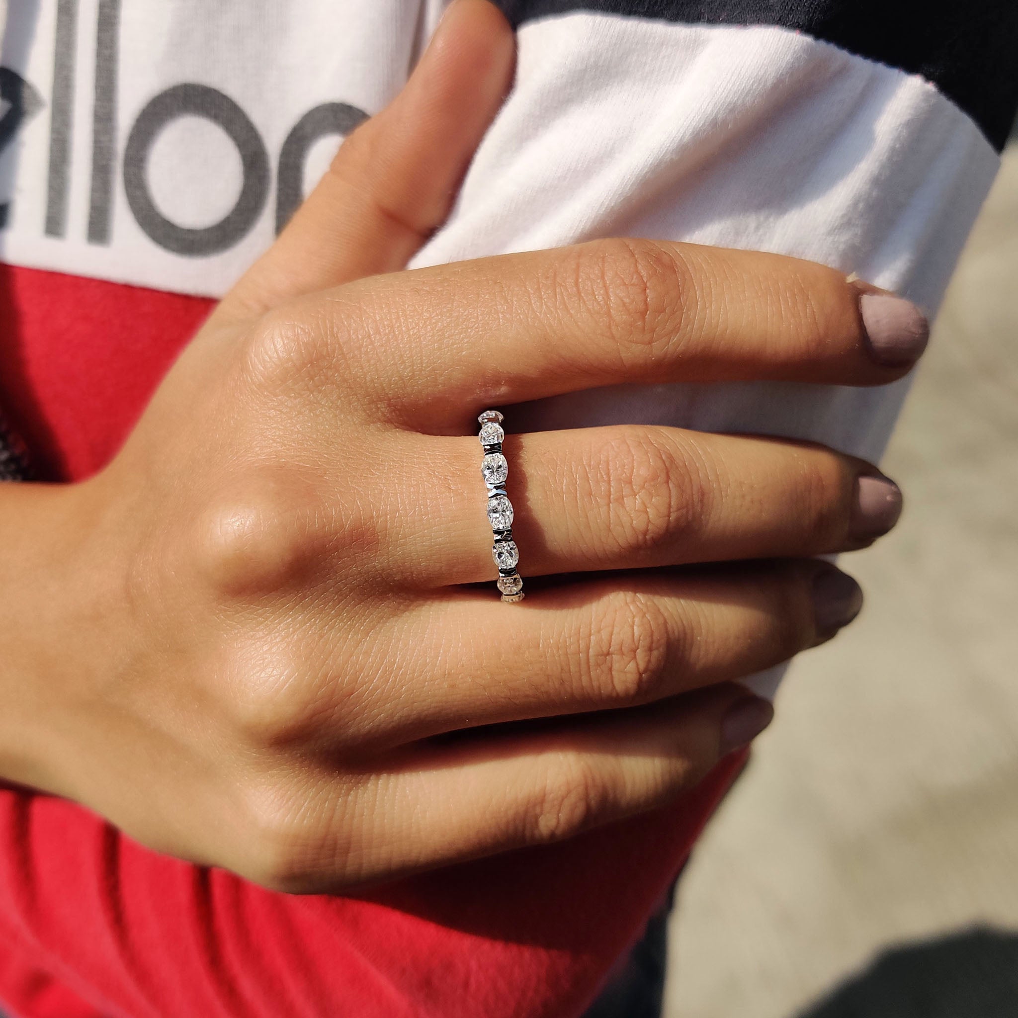 Anniversary band featuring oval moissanite in a white gold eternity design.