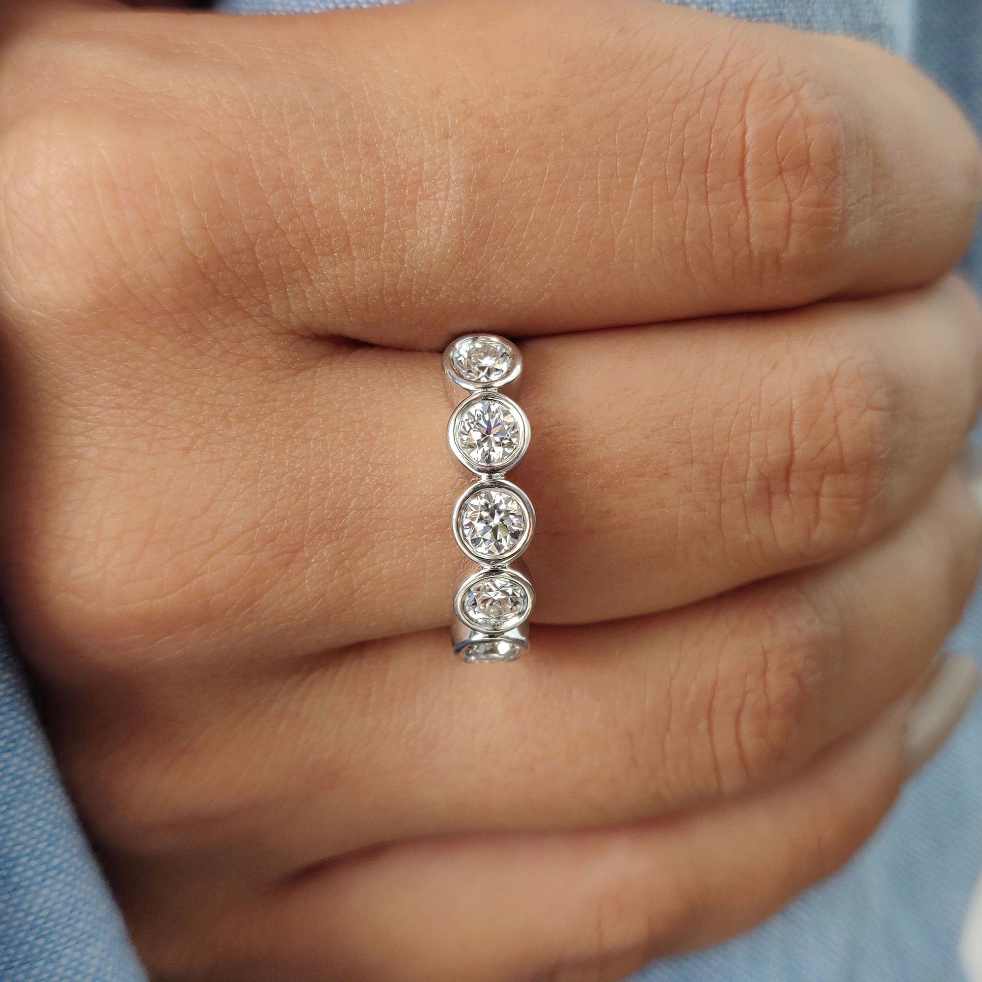 Handmade moissanite band featuring round-cut stones.
