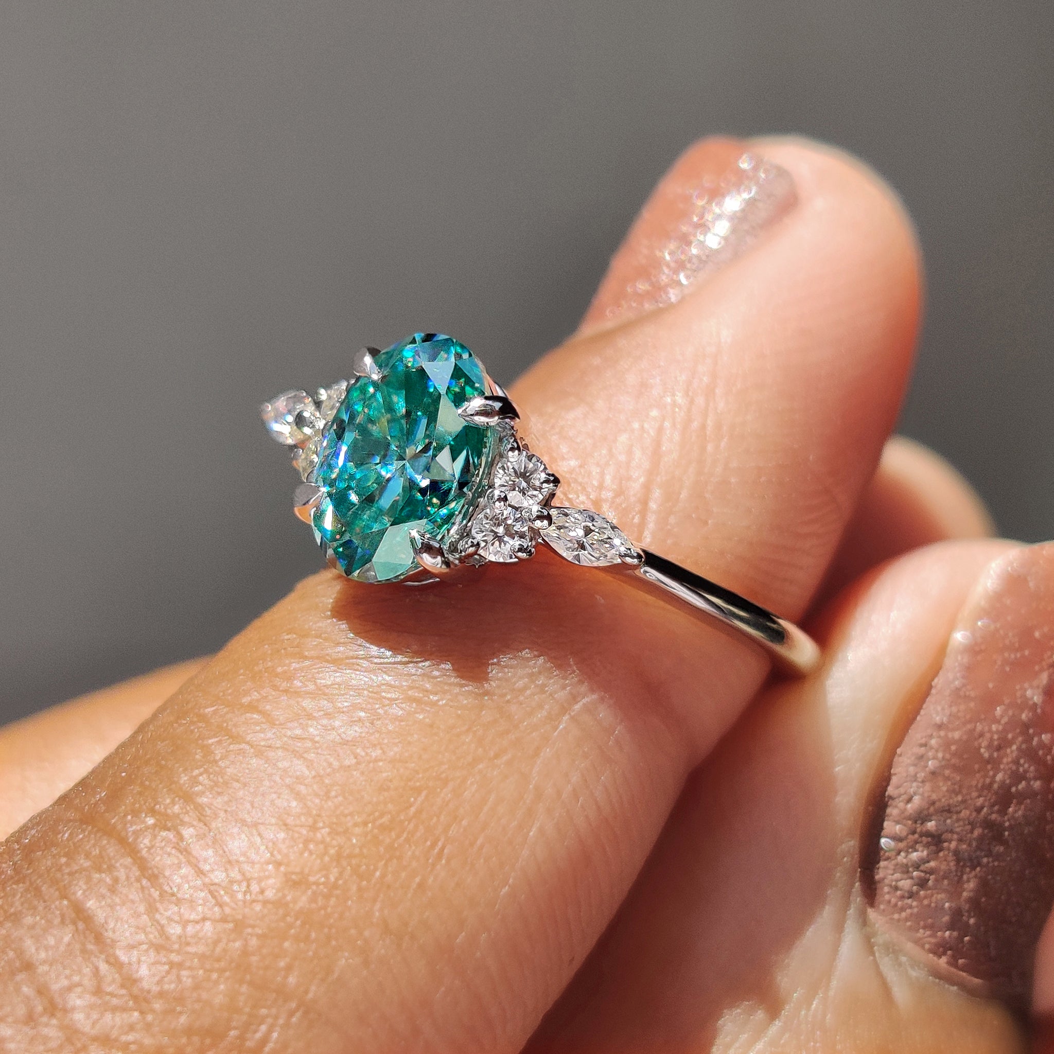 White gold ring paired with a Cyan Blue moissanite centre.
