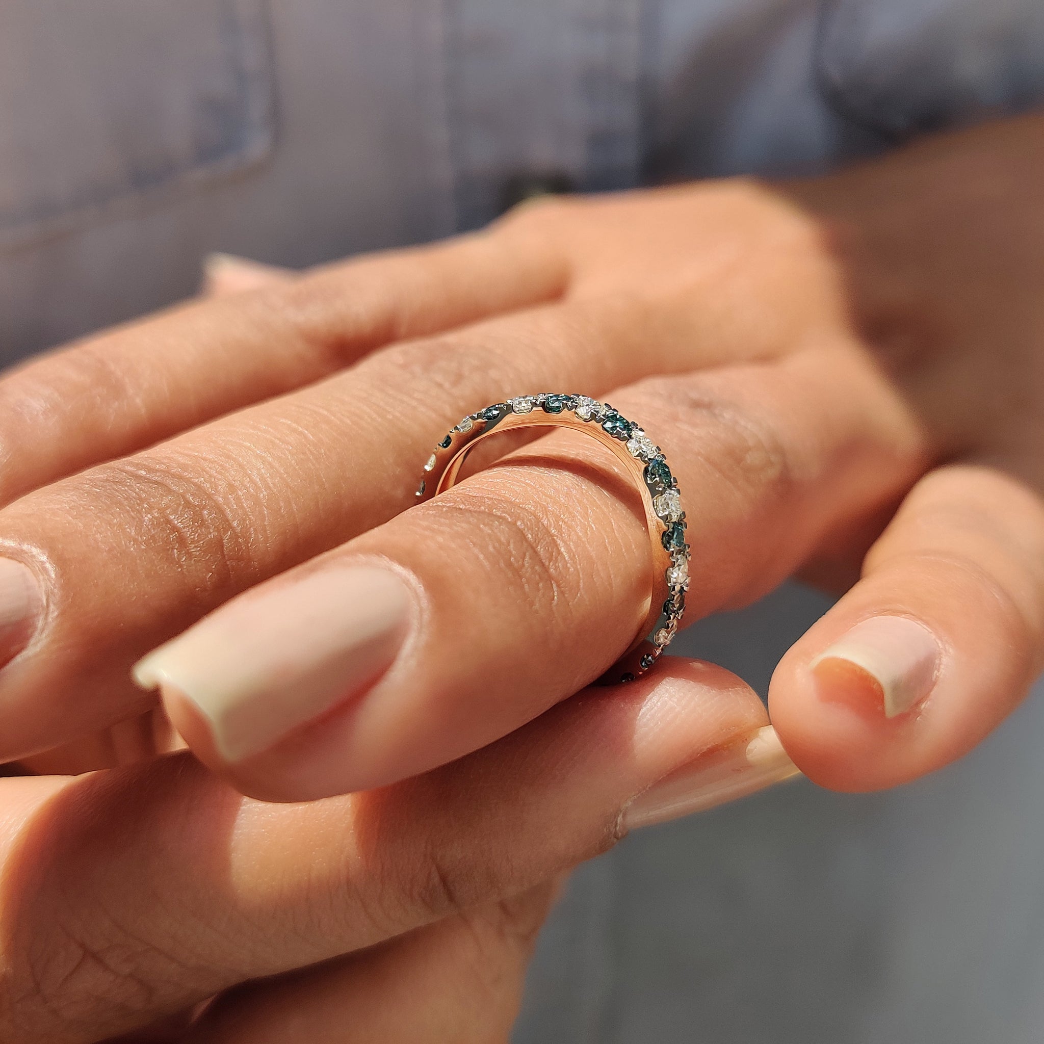 Handmade jewelry piece, a curved wedding band featuring moissanite stones.