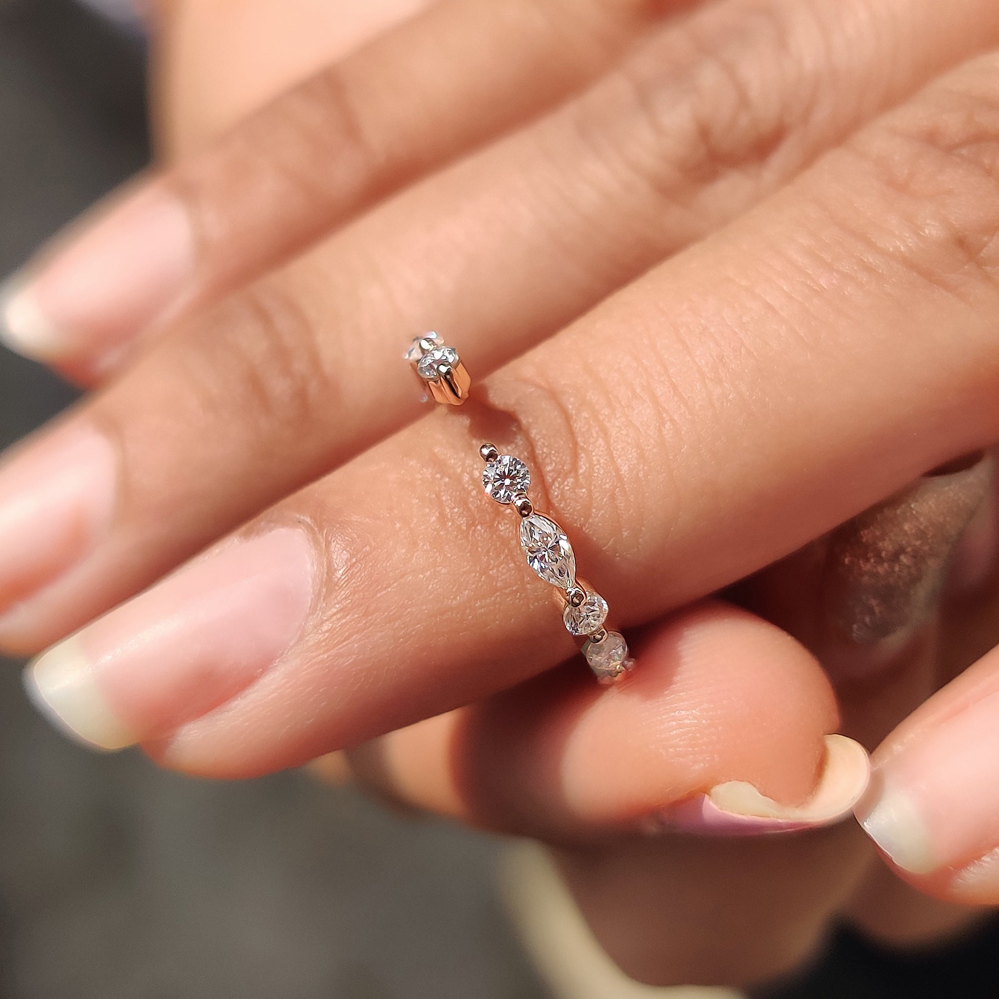 Marquise and round wedding band featuring a unique handmade band with Moissanite.