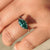 Green marquise ring with double claw prong setting