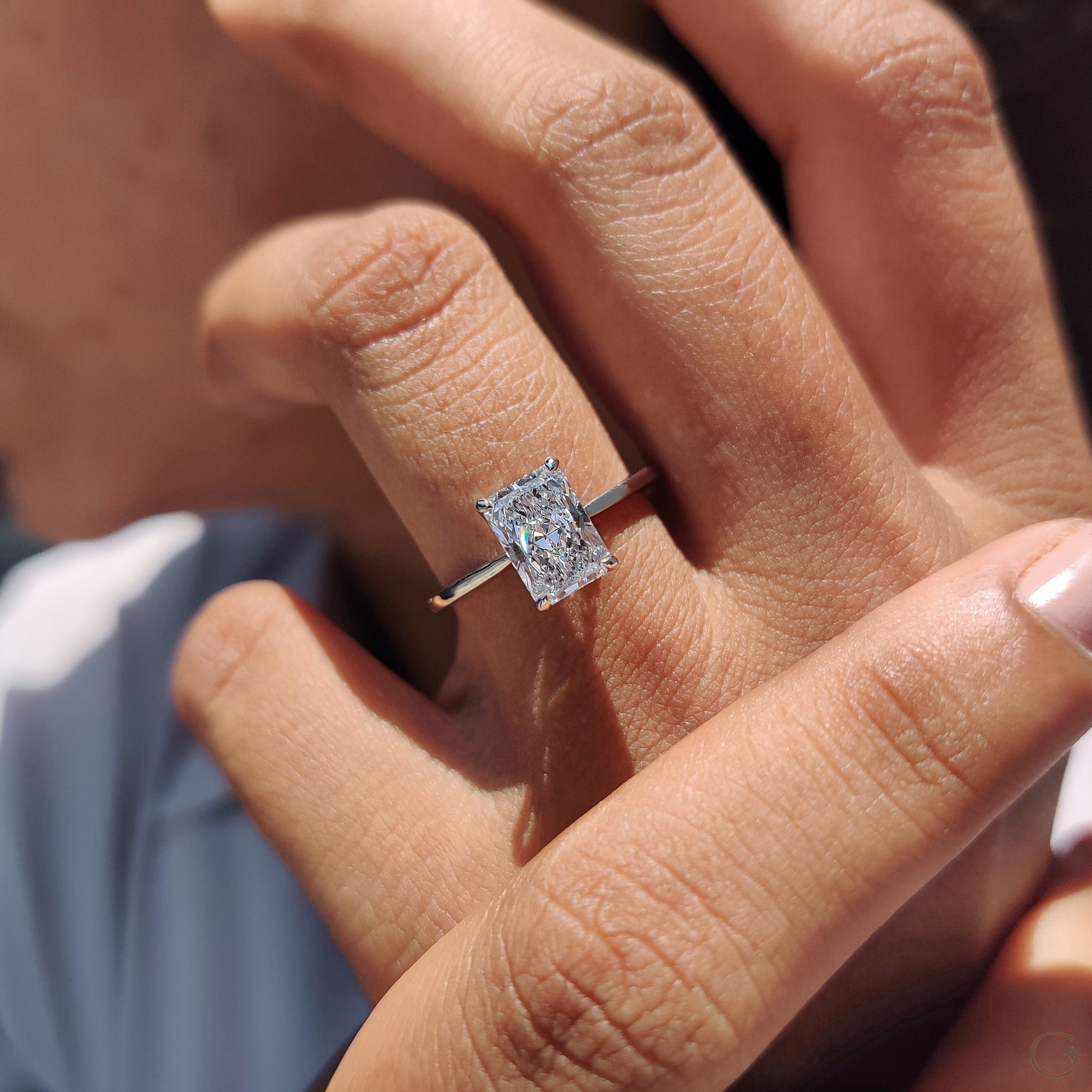 Radiant cut solitaire ring with sparkling brilliance.
