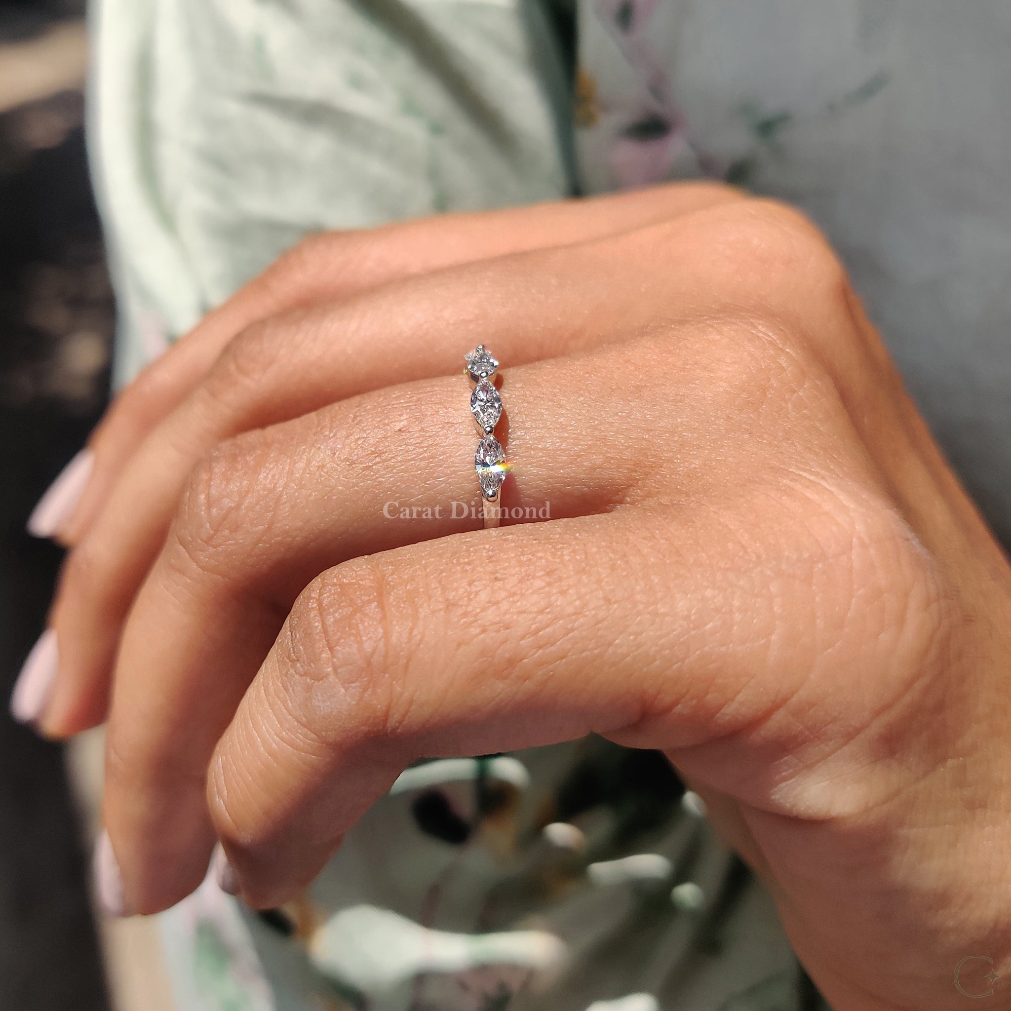 Two round-cut diamonds set in a shared prong wedding band.
