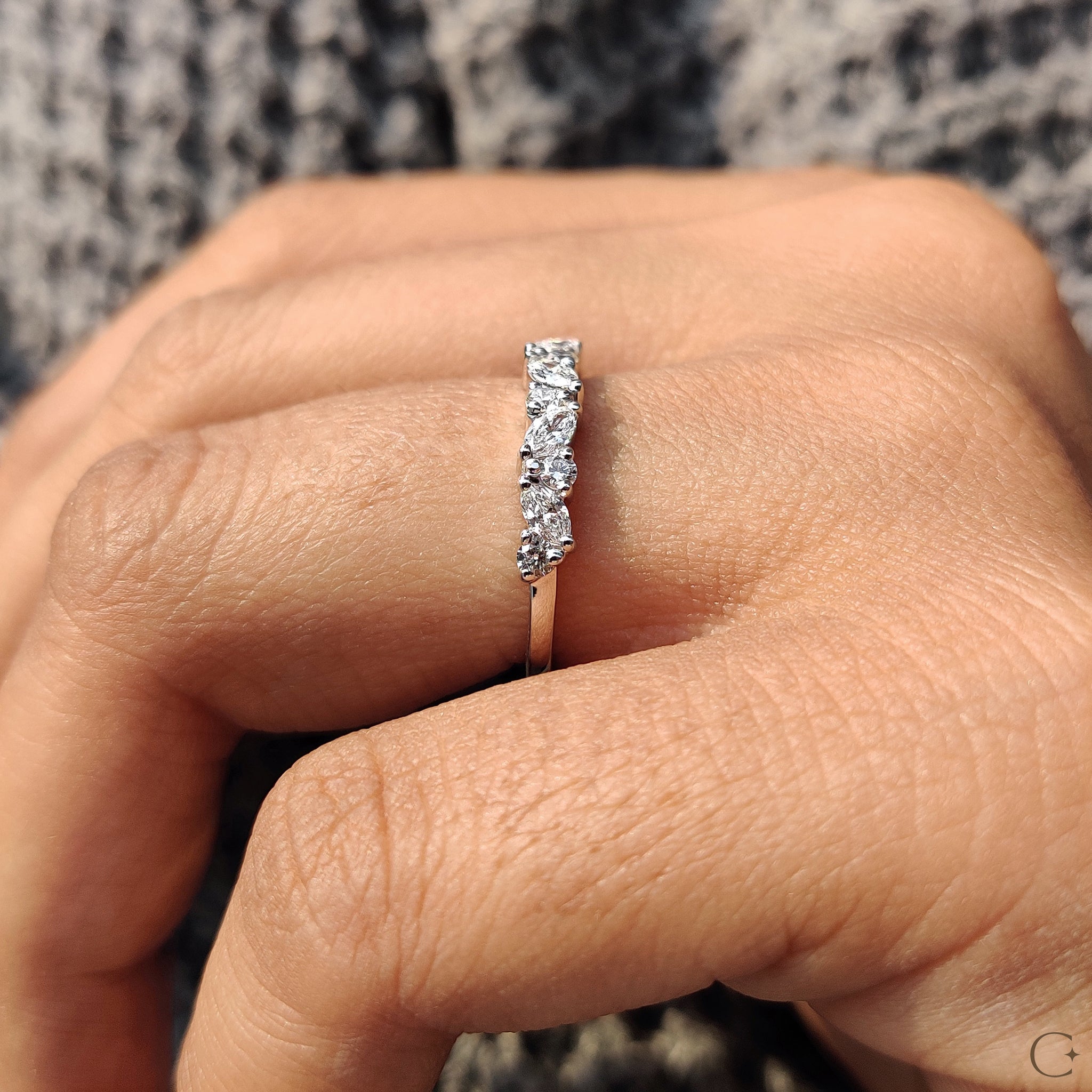 Prong set wedding band handcrafted in white gold.
