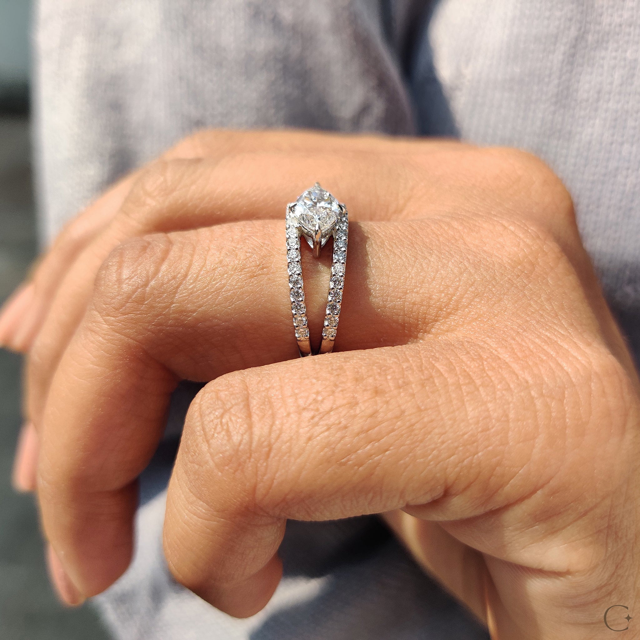 Marquise diamond ring with split pave shank design.
