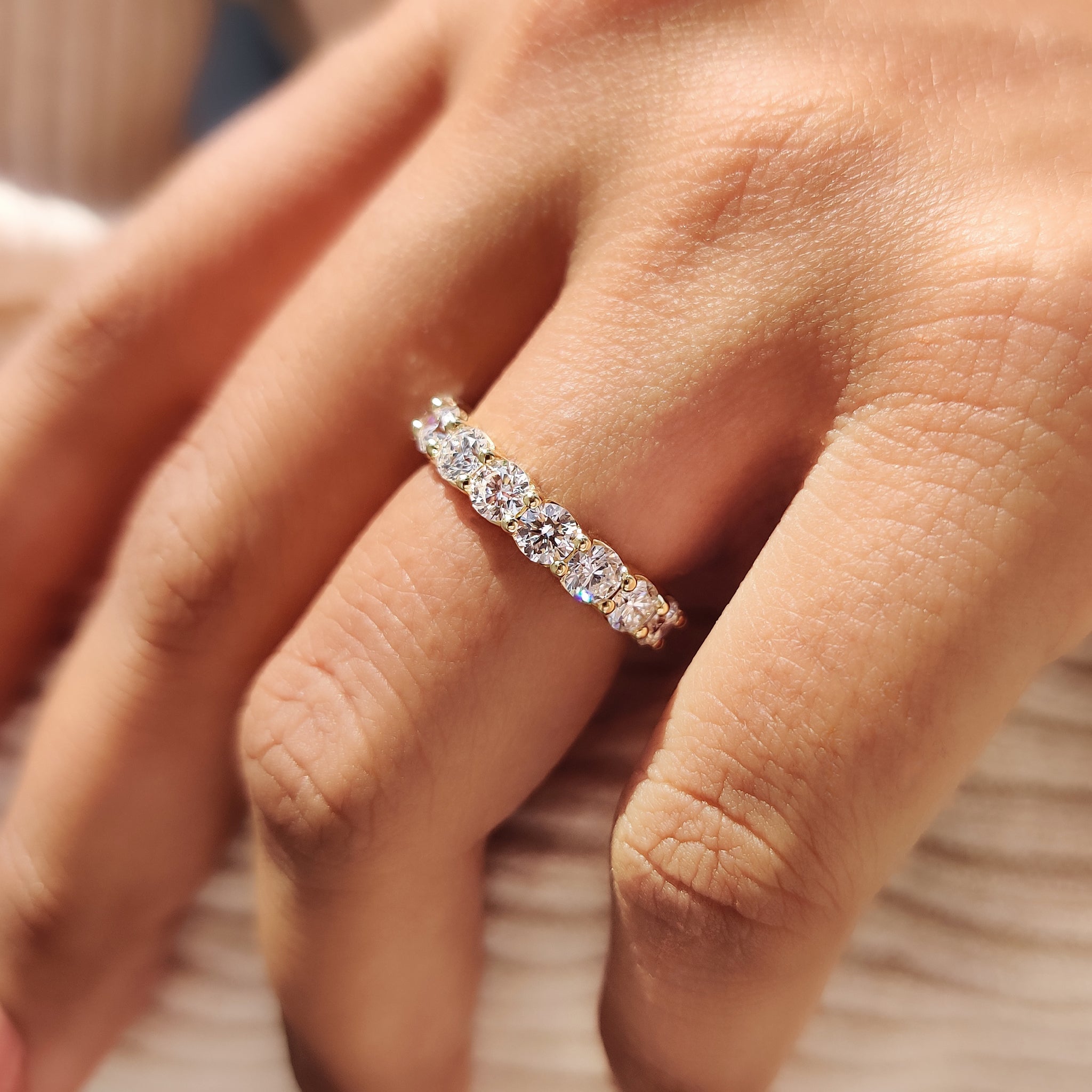 Round diamond wedding band with elegant prong setting.
