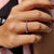 Stackable wedding band with round moissanite stones, designed for easy layering or solo wear.