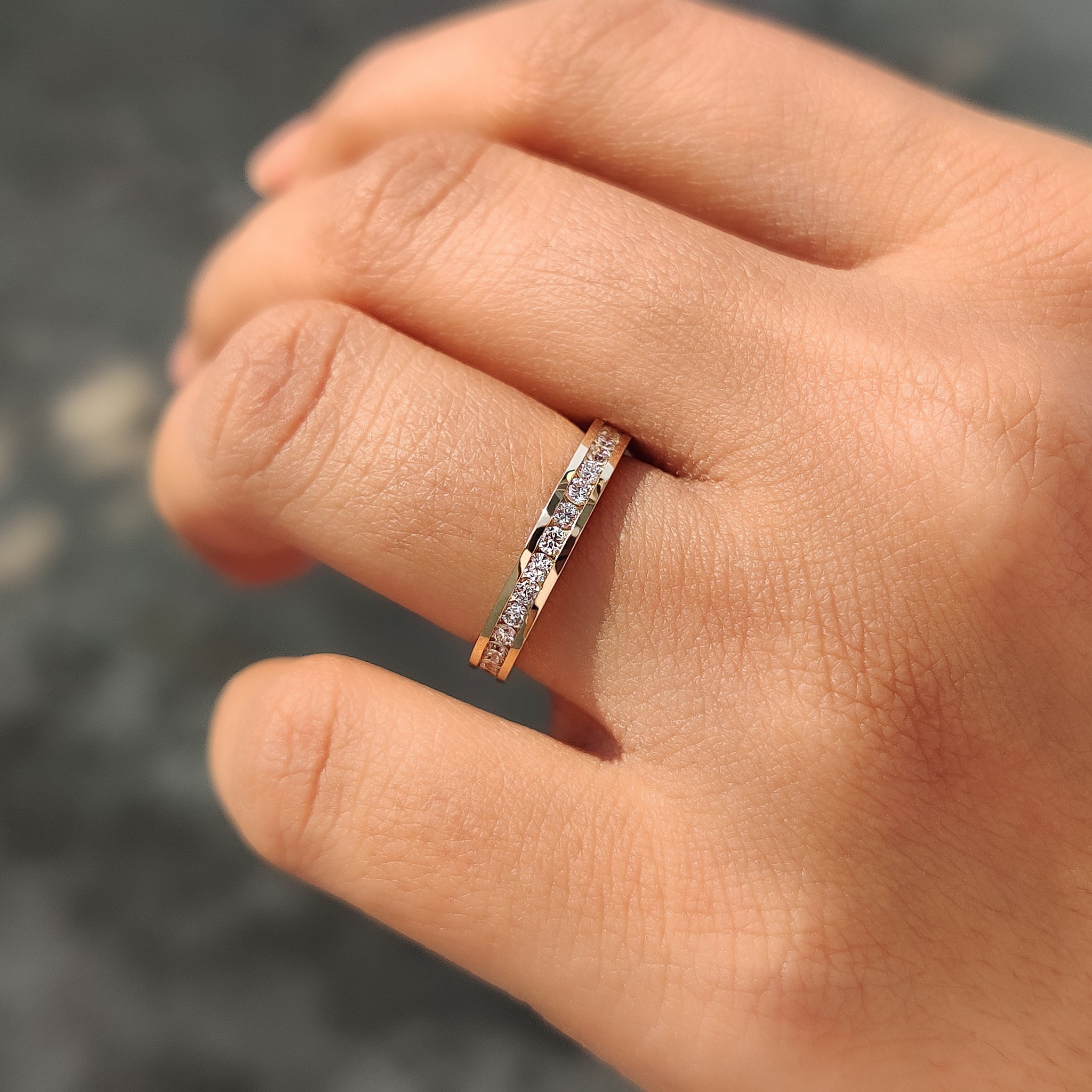 Channel set wedding band with round diamonds set in yellow gold.
