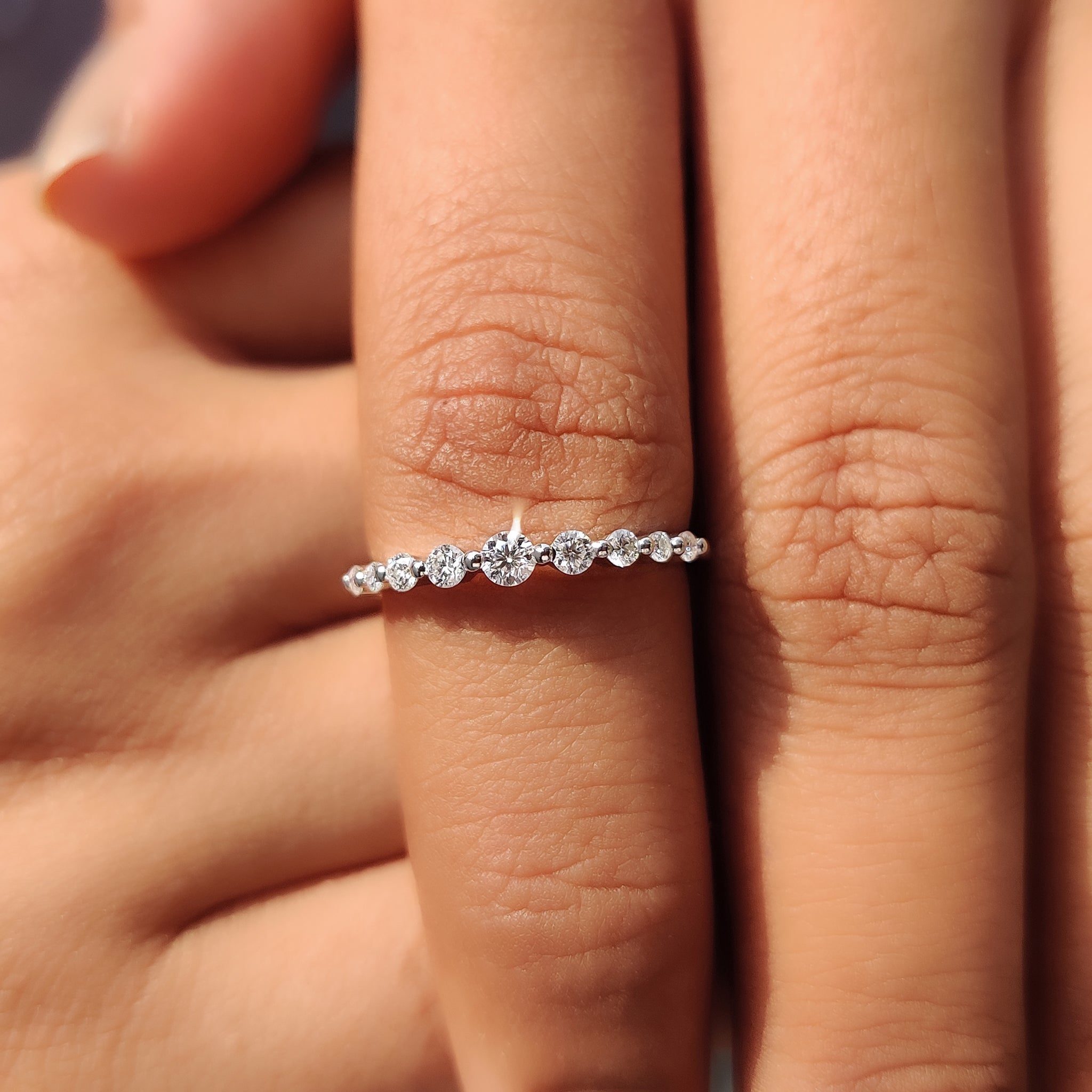 White gold wedding band with shared prong setting.